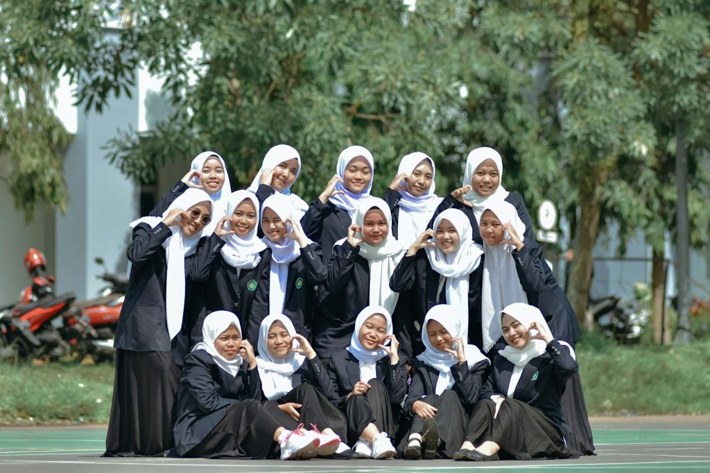 A group of women in black dresses posing for a picture
