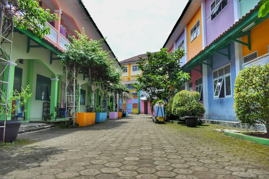 a cobblestone street lined with colorful houses